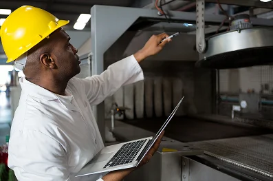 male-worker-wearing-lab-coat-while-using-laptop